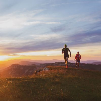 ultra runners at sunset